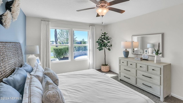 carpeted bedroom with baseboards and a ceiling fan