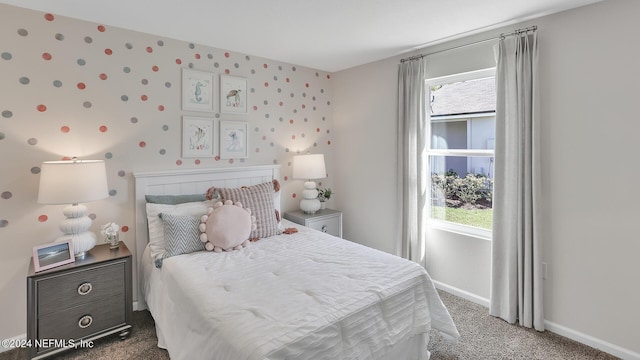 bedroom featuring carpet and baseboards