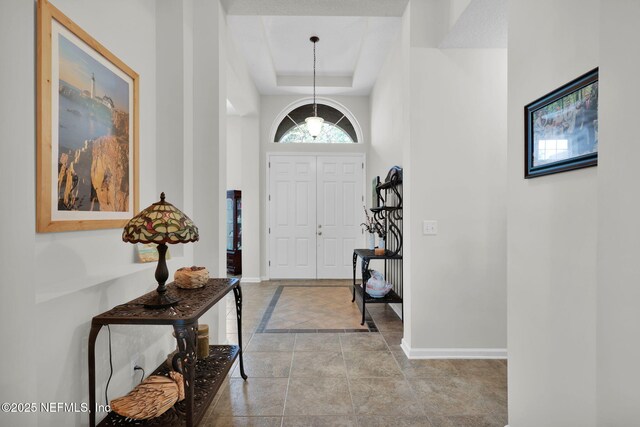 809 Ifield Rd, Saint Augustine, FL 32095 - entrance foyer featuring baseboards and a tray ceiling
