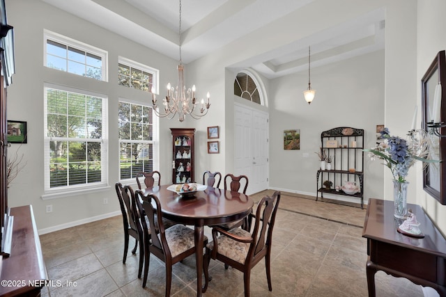 809 Ifield Rd, Saint Augustine, FL 32095 - dining space with a towering ceiling, a tray ceiling, light tile patterned floors, and healthy amount of natural light