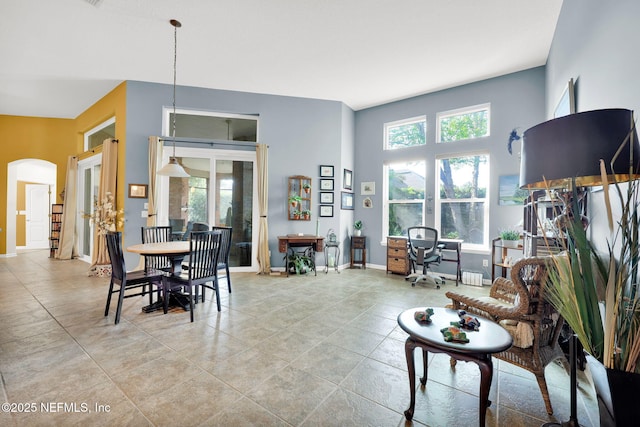 809 Ifield Rd, Saint Augustine, FL 32095 - living area featuring arched walkways, baseboards, and a desk