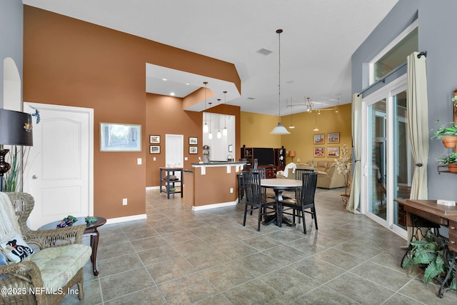 809 Ifield Rd, Saint Augustine, FL 32095 - dining space featuring a towering ceiling, tile patterned floors, and baseboards