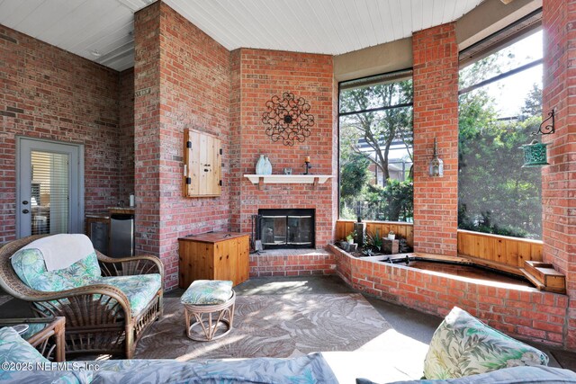 809 Ifield Rd, Saint Augustine, FL 32095 - carpeted living area featuring an outdoor brick fireplace and brick wall