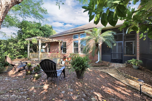 809 Ifield Rd, Saint Augustine, FL 32095 - rear view of property with brick siding, a pergola, and a sunroom