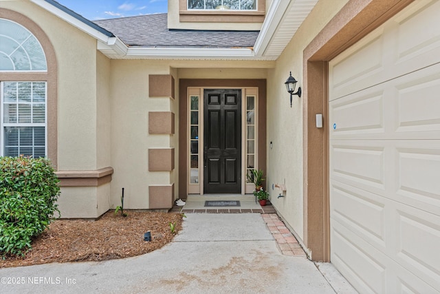 13111 Hammock Cir S, Jacksonville, FL 32225 - doorway to property with roof with shingles, stucco siding, and an attached garage