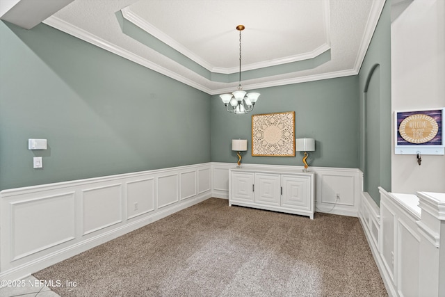 13111 Hammock Cir S, Jacksonville, FL 32225 - unfurnished room featuring ornamental molding, a raised ceiling, a decorative wall, a chandelier, and wainscoting
