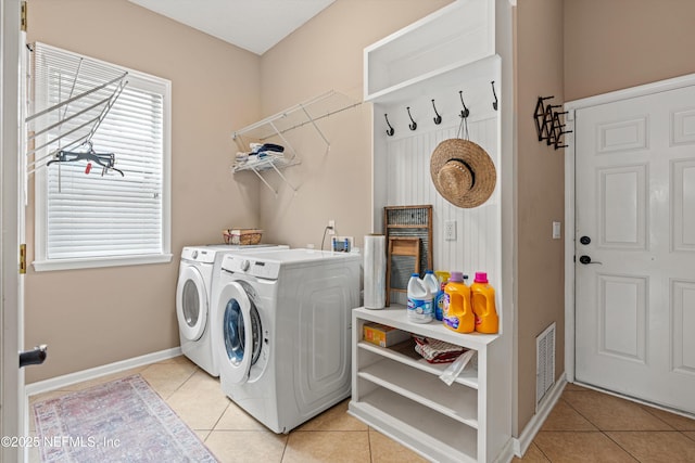13111 Hammock Cir S, Jacksonville, FL 32225 - laundry room with washing machine and clothes dryer, light tile patterned floors, and baseboards
