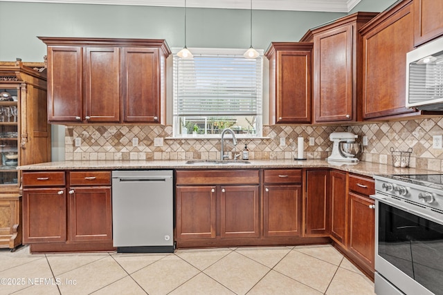 13111 Hammock Cir S, Jacksonville, FL 32225 - kitchen with stainless steel appliances, a sink, light tile patterned flooring, light stone countertops, and ornamental molding