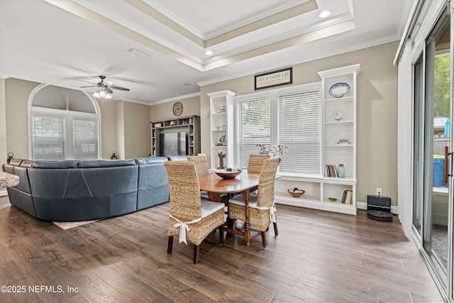 13111 Hammock Cir S, Jacksonville, FL 32225 - dining space featuring ornamental molding, dark wood-style floors, ceiling fan, a tray ceiling, and recessed lighting
