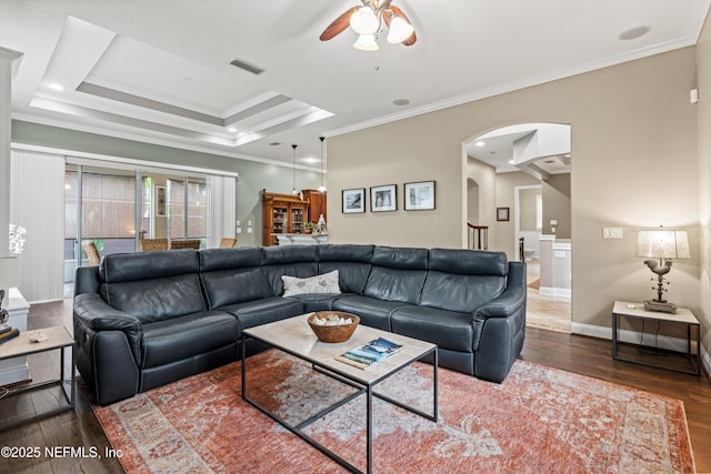 13111 Hammock Cir S, Jacksonville, FL 32225 - living room with crown molding, ceiling fan, arched walkways, wood finished floors, and baseboards