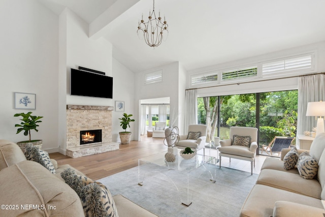 90 Players Club Villas Rd, Ponte Vedra Beach, FL 32082 - living room with wood finished floors, high vaulted ceiling, beam ceiling, baseboards, and a stone fireplace