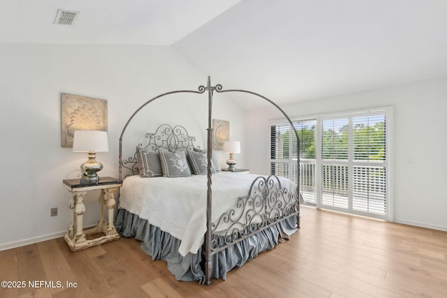 90 Players Club Villas Rd, Ponte Vedra Beach, FL 32082 - bedroom with lofted ceiling, wood finished floors, visible vents, and access to exterior