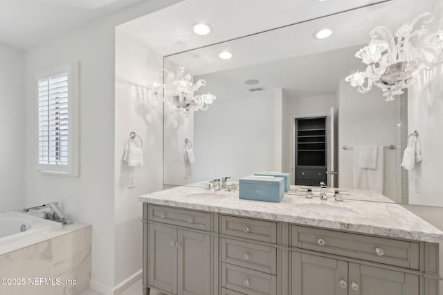 90 Players Club Villas Rd, Ponte Vedra Beach, FL 32082 - bathroom featuring a sink, a chandelier, double vanity, and a garden tub