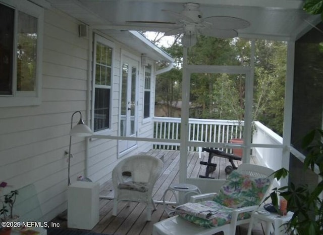sunroom with ceiling fan and french doors