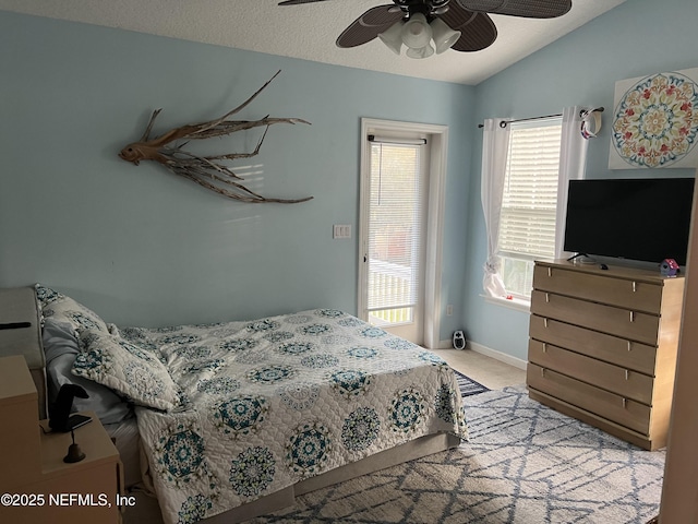 bedroom featuring carpet, baseboards, vaulted ceiling, and ceiling fan