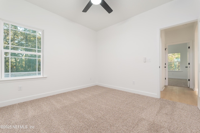 5821 Silver Sands Cir, Keystone Heights, FL 32656 - empty room featuring light colored carpet, baseboards, and a ceiling fan