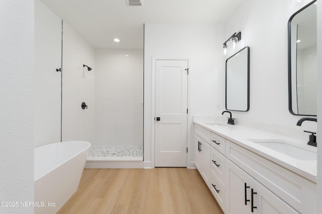 5821 Silver Sands Cir, Keystone Heights, FL 32656 - bathroom featuring a sink, double vanity, wood finished floors, and a tile shower