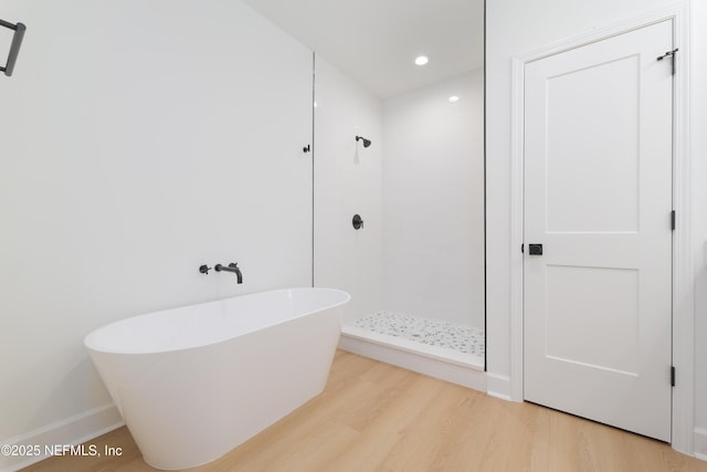 5821 Silver Sands Cir, Keystone Heights, FL 32656 - bathroom featuring a tile shower, recessed lighting, a freestanding bath, and wood finished floors