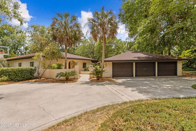 1315 Autumn Trce, Fernandina Beach, FL 32034 - view of front facade with stucco siding and a detached garage