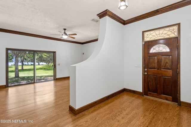 1315 Autumn Trce, Fernandina Beach, FL 32034 - foyer with wood finished floors, ornamental molding, visible vents, ceiling fan, and baseboards