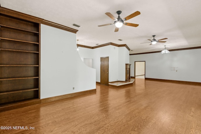 1315 Autumn Trce, Fernandina Beach, FL 32034 - unfurnished living room featuring a ceiling fan, baseboards, visible vents, crown molding, and wood finished floors