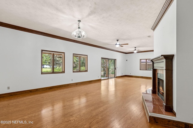 1315 Autumn Trce, Fernandina Beach, FL 32034 - unfurnished living room featuring a textured ceiling, wood finished floors, and ornamental molding
