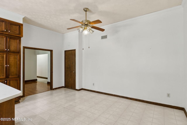 1315 Autumn Trce, Fernandina Beach, FL 32034 - empty room featuring light floors, visible vents, baseboards, a textured ceiling, and ceiling fan