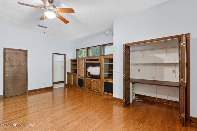 1315 Autumn Trce, Fernandina Beach, FL 32034 - unfurnished living room with baseboards, visible vents, wood finished floors, and a ceiling fan