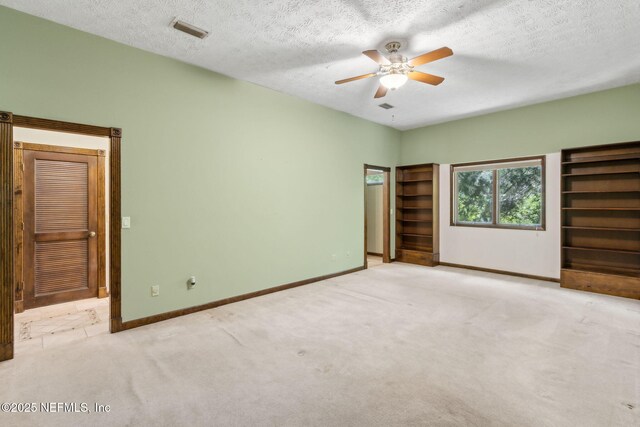 1315 Autumn Trce, Fernandina Beach, FL 32034 - unfurnished bedroom featuring carpet floors, a textured ceiling, visible vents, baseboards, and ceiling fan