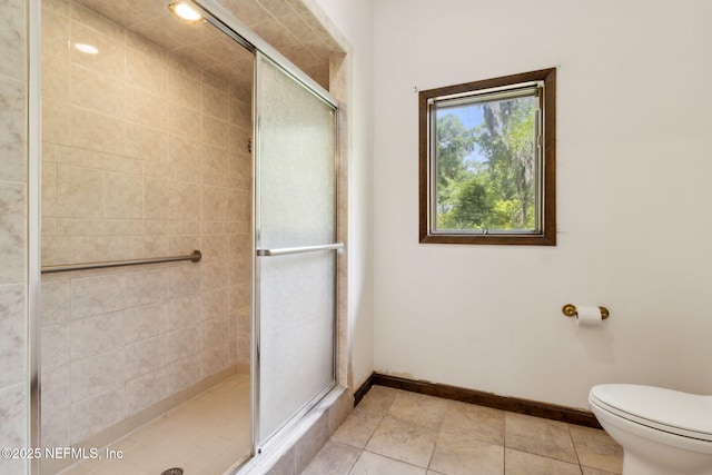 1315 Autumn Trce, Fernandina Beach, FL 32034 - bathroom with a stall shower, baseboards, tile patterned floors, and toilet