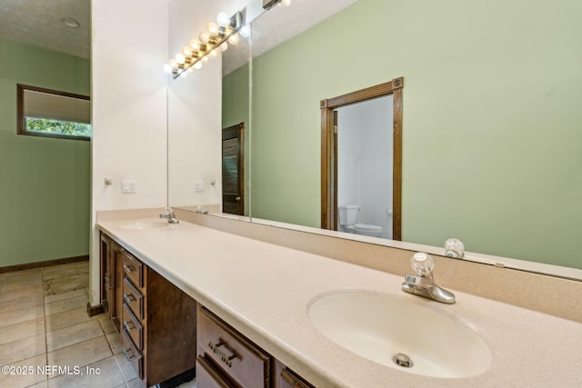 1315 Autumn Trce, Fernandina Beach, FL 32034 - bathroom with a sink, double vanity, toilet, and tile patterned flooring
