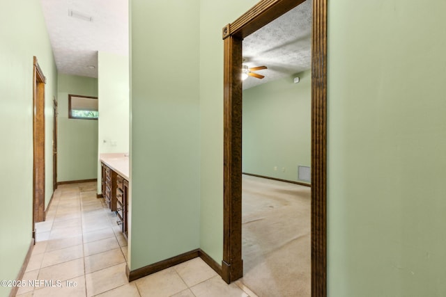 1315 Autumn Trce, Fernandina Beach, FL 32034 - hallway with a textured ceiling, baseboards, light tile patterned floors, and visible vents