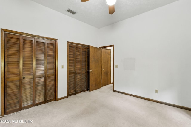 1315 Autumn Trce, Fernandina Beach, FL 32034 - unfurnished bedroom featuring light colored carpet, visible vents, baseboards, and multiple closets