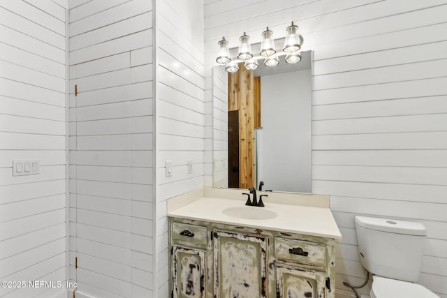 1315 Autumn Trce, Fernandina Beach, FL 32034 - half bathroom with toilet, wooden walls, and vanity