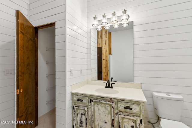 1315 Autumn Trce, Fernandina Beach, FL 32034 - bathroom with toilet, wooden walls, and vanity