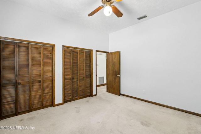 1315 Autumn Trce, Fernandina Beach, FL 32034 - unfurnished bedroom featuring baseboards, light carpet, visible vents, and two closets