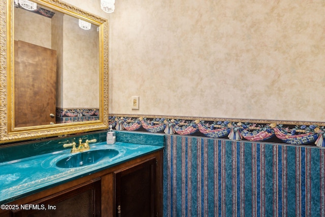 1315 Autumn Trce, Fernandina Beach, FL 32034 - bathroom featuring vanity, wallpapered walls, and a wainscoted wall