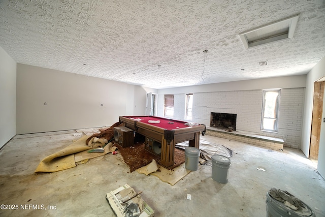 9441 Devonshire Blvd, Jacksonville, FL 32208 - recreation room with concrete flooring, a textured ceiling, attic access, a brick fireplace, and billiards