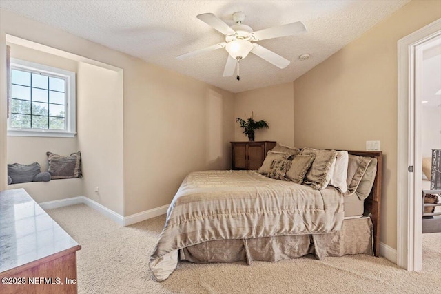 carpeted bedroom with a textured ceiling, baseboards, and ceiling fan