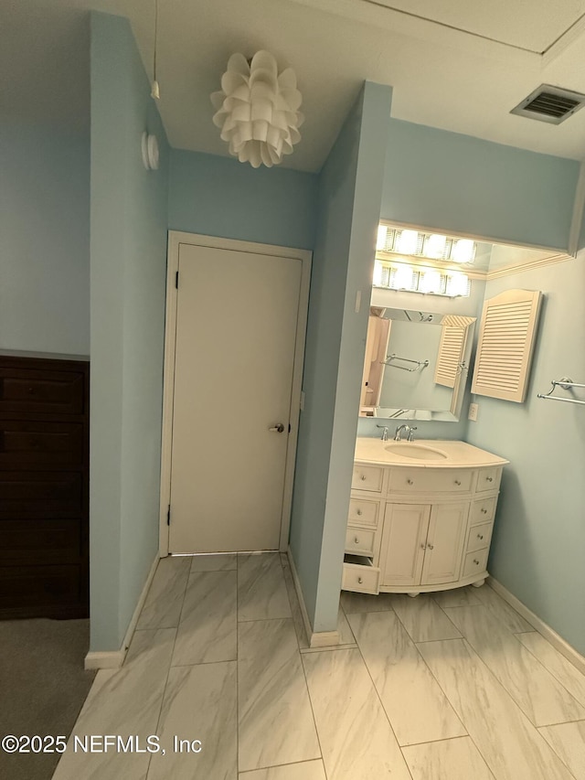 9252 San Jose Blvd Unit 3802, Jacksonville, FL 32257 - bathroom featuring marble look tile flooring, baseboards, and vanity