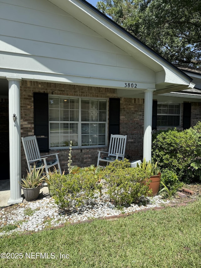 9252 San Jose Blvd Unit 3802, Jacksonville, FL 32257 - doorway to property with brick siding and covered porch