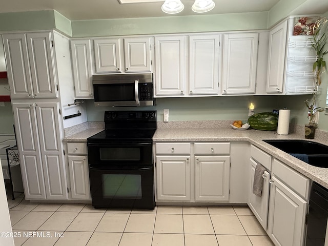 9252 San Jose Blvd Unit 3802, Jacksonville, FL 32257 - kitchen with black appliances, light countertops, light tile patterned flooring, and white cabinets