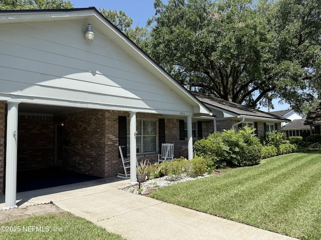 9252 San Jose Blvd Unit 3802, Jacksonville, FL 32257 - view of front of property featuring covered porch, a front yard, and brick siding