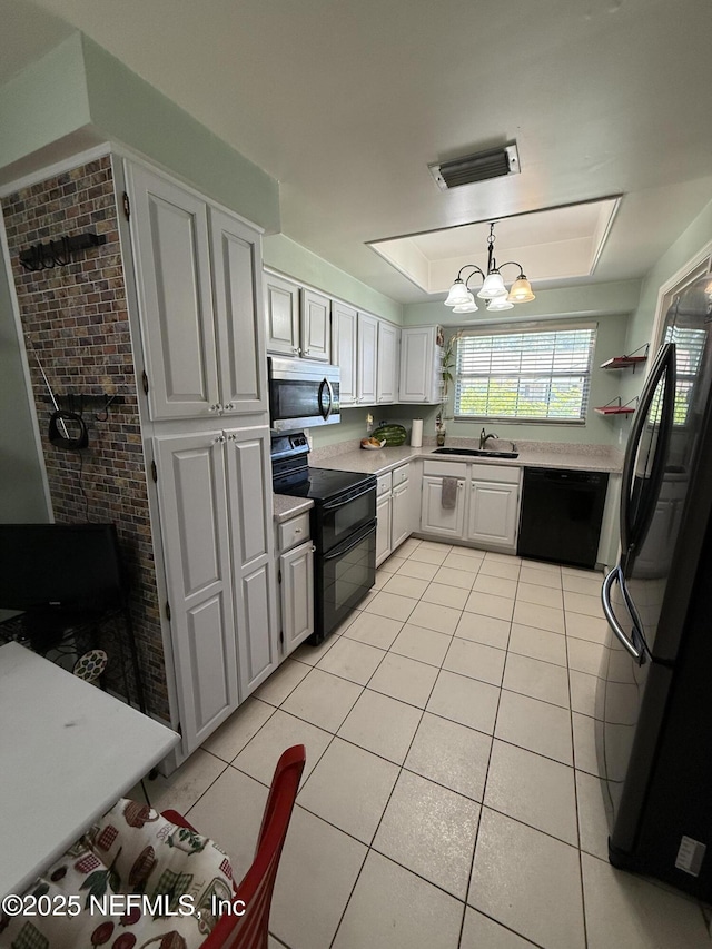 9252 San Jose Blvd Unit 3802, Jacksonville, FL 32257 - kitchen featuring black appliances, a sink, light countertops, light tile patterned floors, and a chandelier