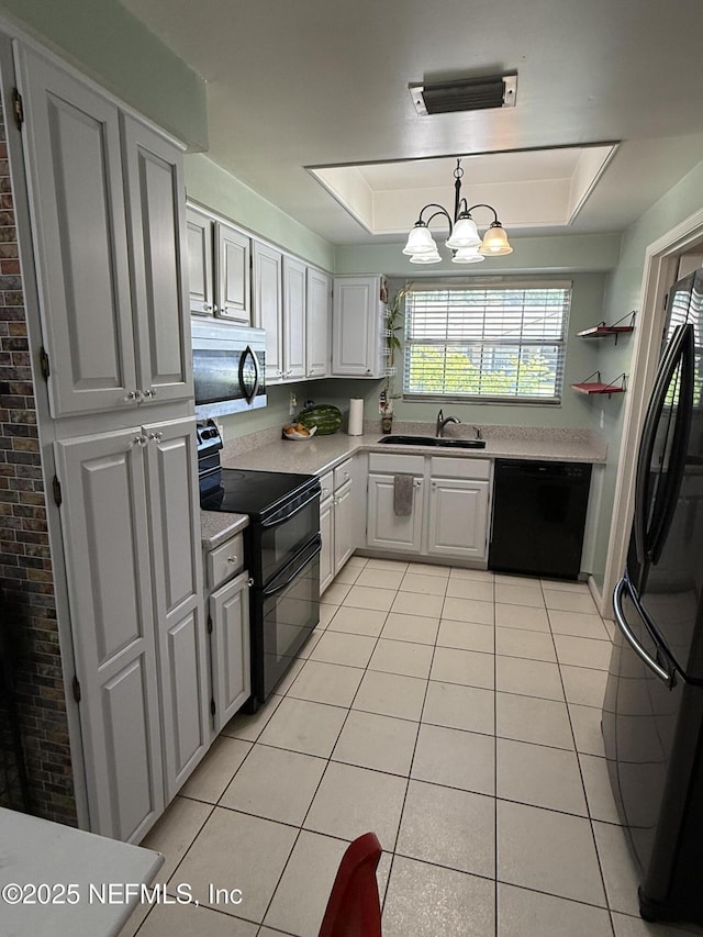 9252 San Jose Blvd Unit 3802, Jacksonville, FL 32257 - kitchen featuring black appliances, a sink, light countertops, light tile patterned flooring, and a chandelier