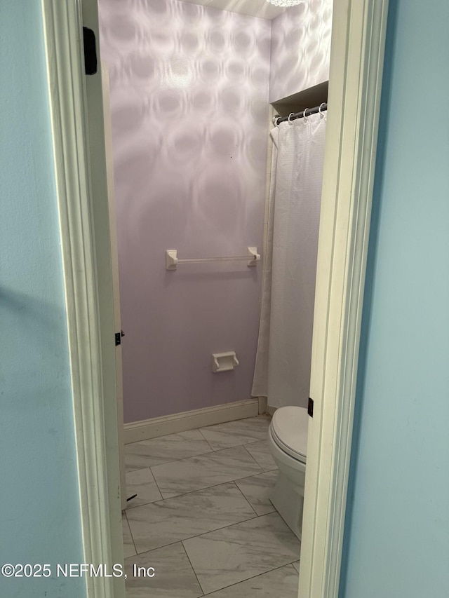 9252 San Jose Blvd Unit 3802, Jacksonville, FL 32257 - full bathroom featuring marble look tile flooring, toilet, and baseboards