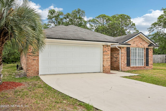 ranch-style home featuring brick siding, driveway, and an attached garage