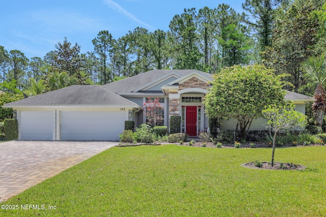 112 Long Branch Way, Saint Augustine, FL 32086 - view of front facade with an attached garage, a front lawn, decorative driveway, and stone siding