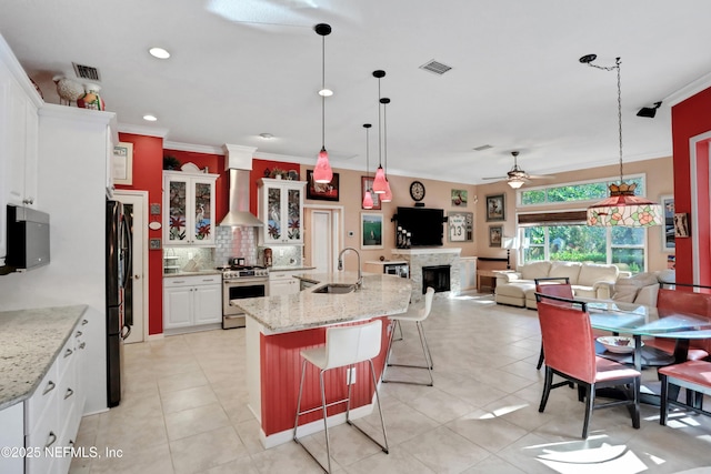 112 Long Branch Way, Saint Augustine, FL 32086 - kitchen with a ceiling fan, freestanding refrigerator, visible vents, gas range, and wall chimney range hood