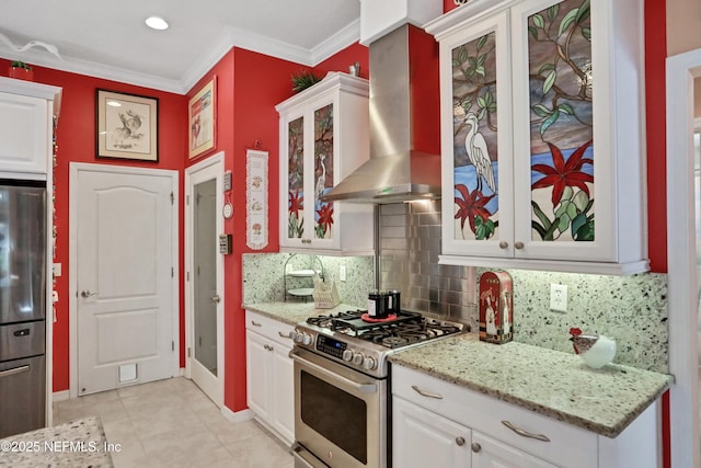 112 Long Branch Way, Saint Augustine, FL 32086 - kitchen with wall chimney exhaust hood, backsplash, white cabinets, light stone countertops, and appliances with stainless steel finishes